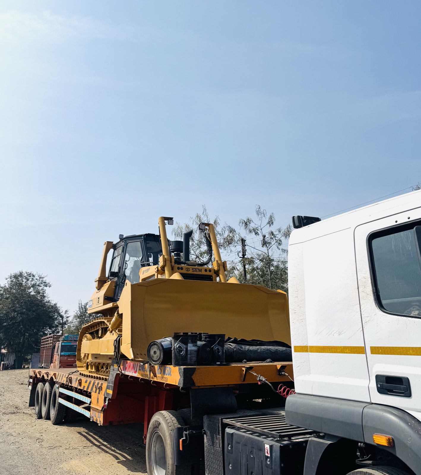CAT bulldozer loaded on a low-bed trailer